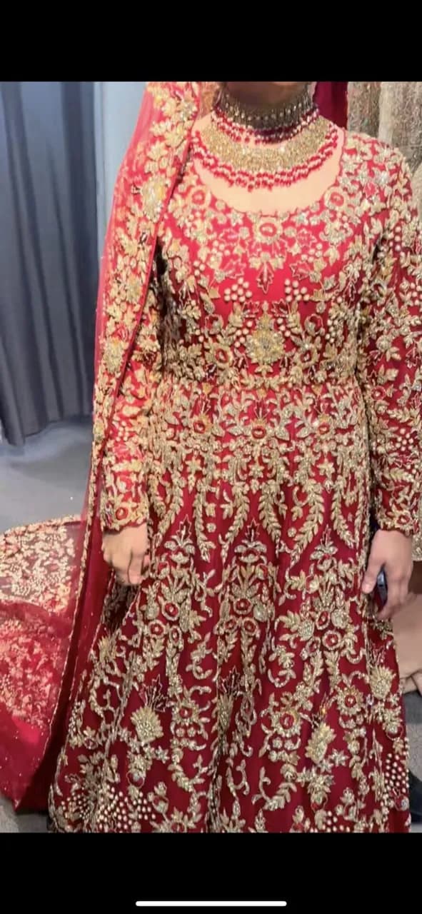 Red and gold embellished lengha with long trail and jewellery thumbnail 2