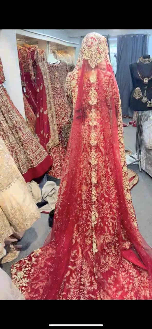 Red and gold embellished lengha with long trail and jewellery thumbnail 4