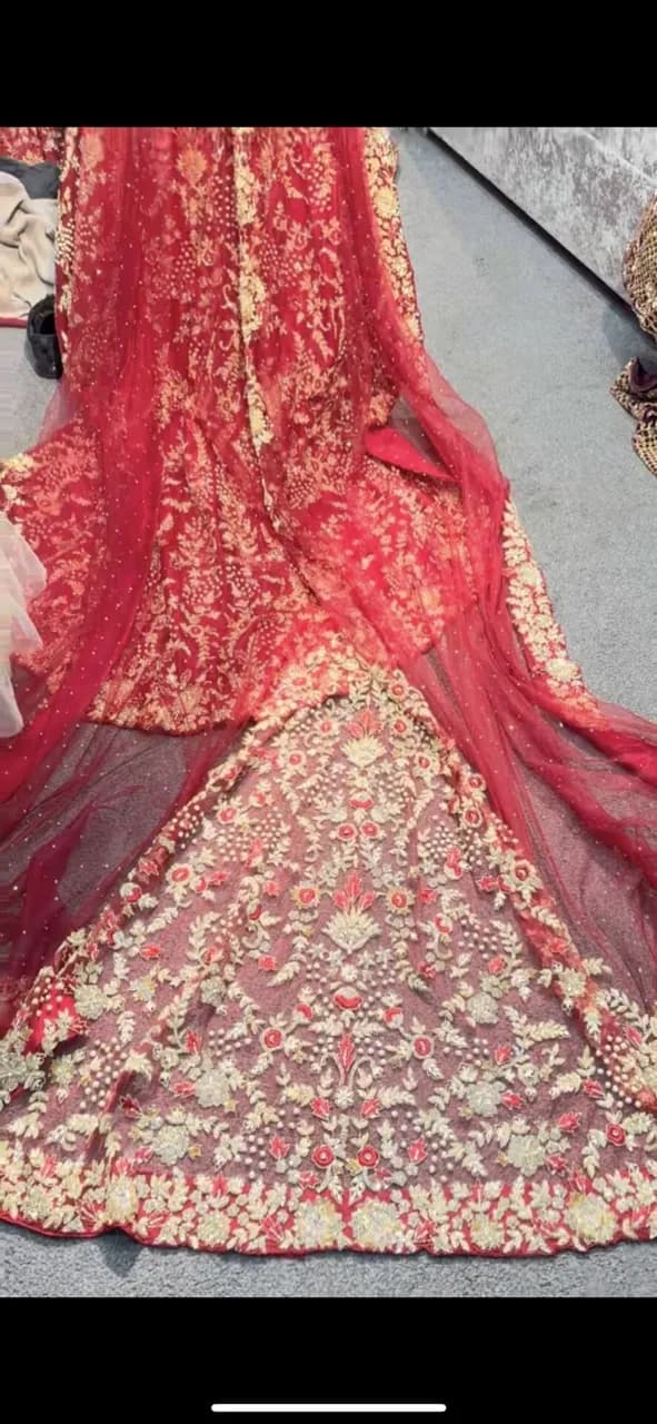 Red and gold embellished lengha with long trail and jewellery thumbnail 5