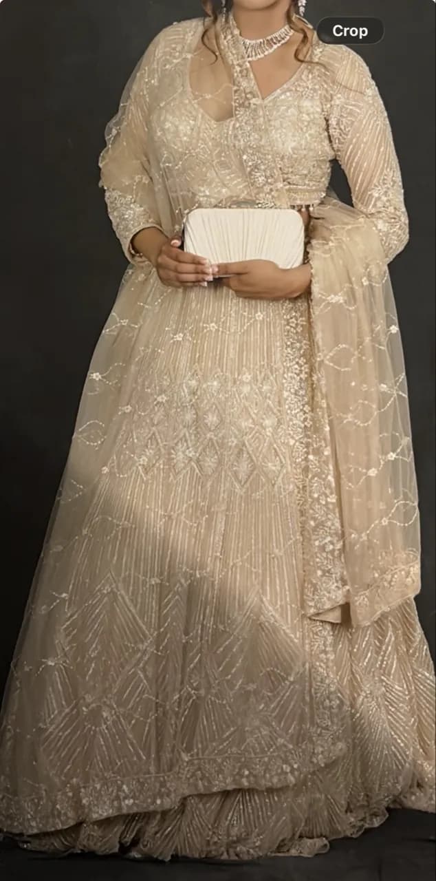 Detailed golden/cream lengha — image 1