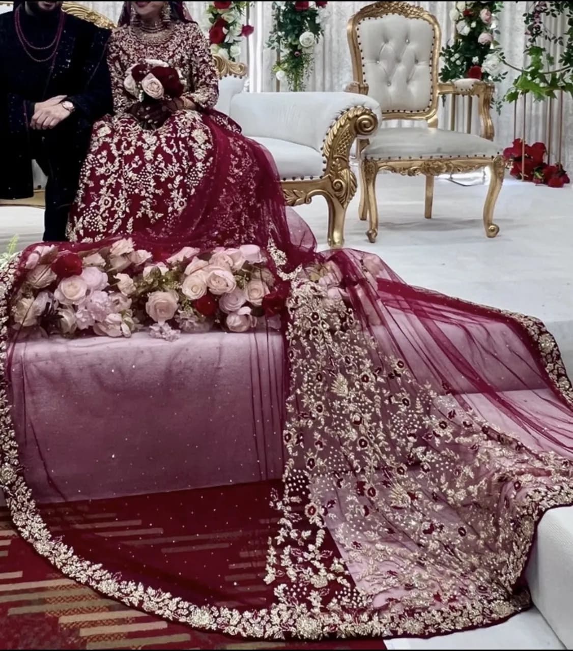 Red and gold embellished lengha with long trail and jewellery — image 1