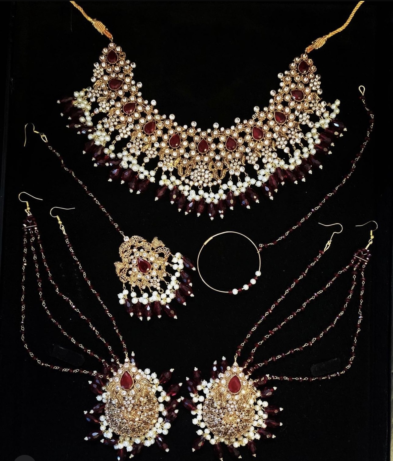 Gold and deep red bridal jewellery with white pearls