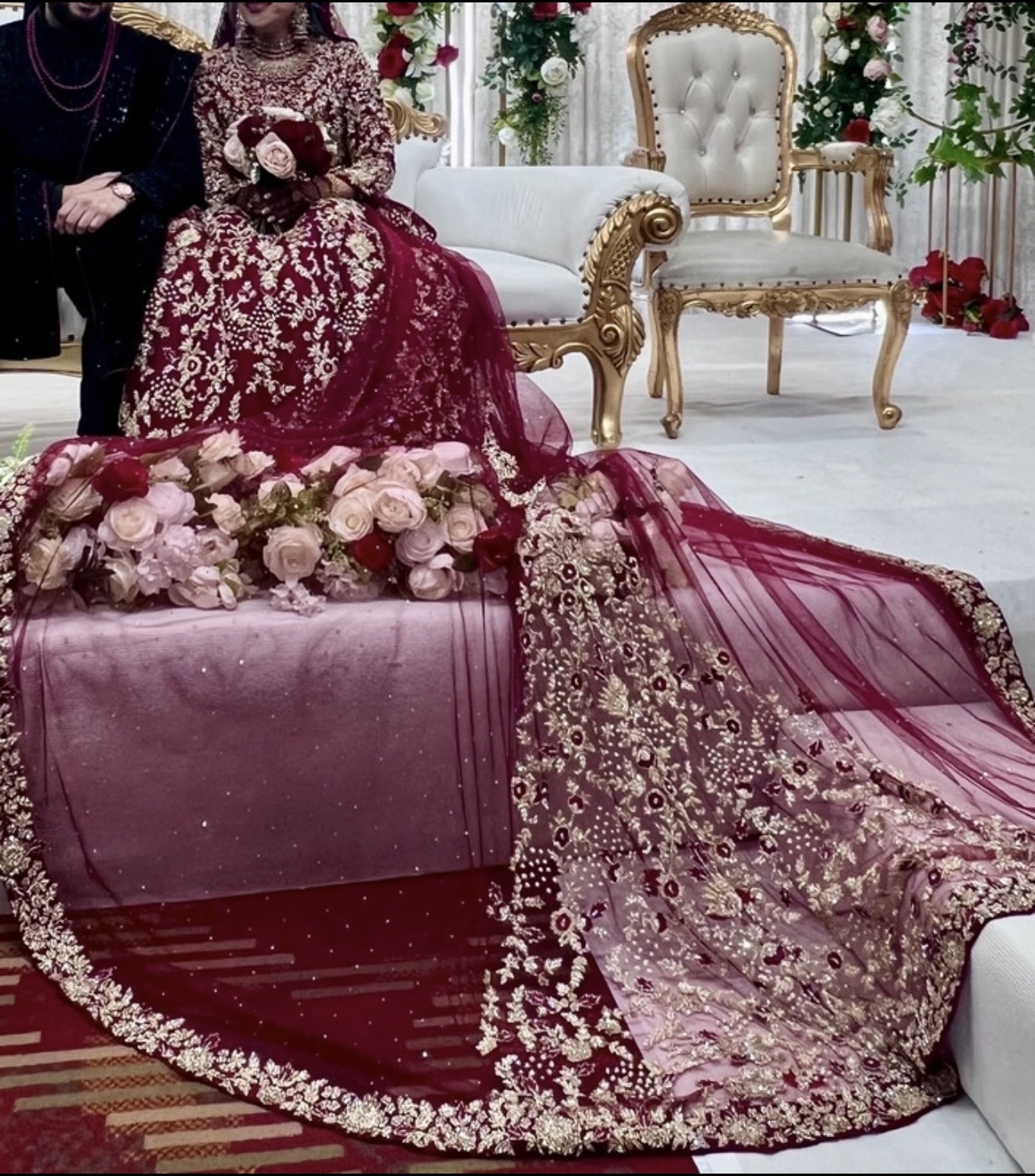 Red and gold embellished lengha with long trail and jewellery