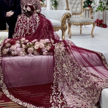 Red and gold embellished lengha with long trail and jewellery